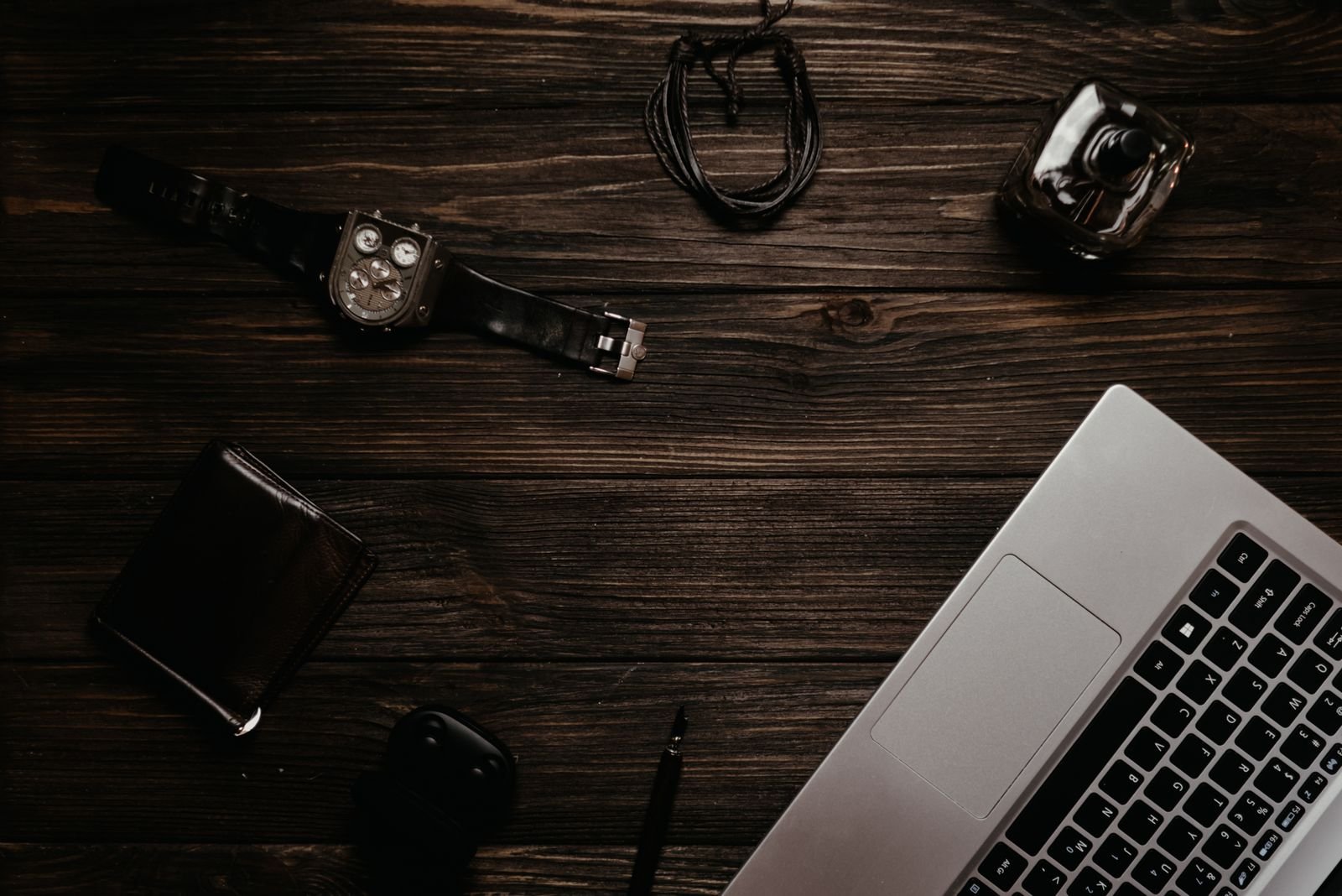 Smartwatch next to a laptop on a desk